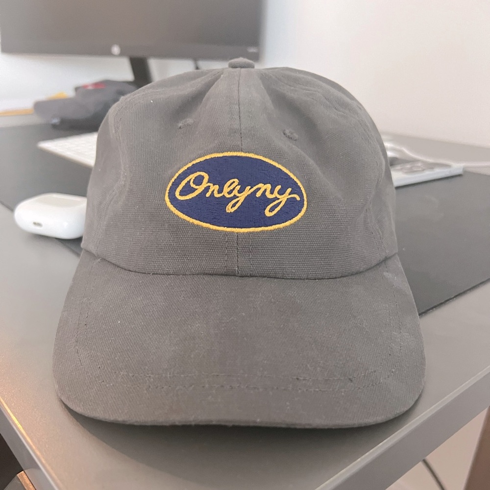 Only NY hat. Grey with blue logo on front. Adjustable strap.